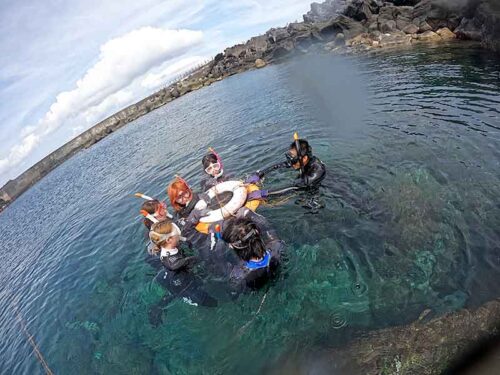 手前のところで浮き輪に掴まり海に慣れ